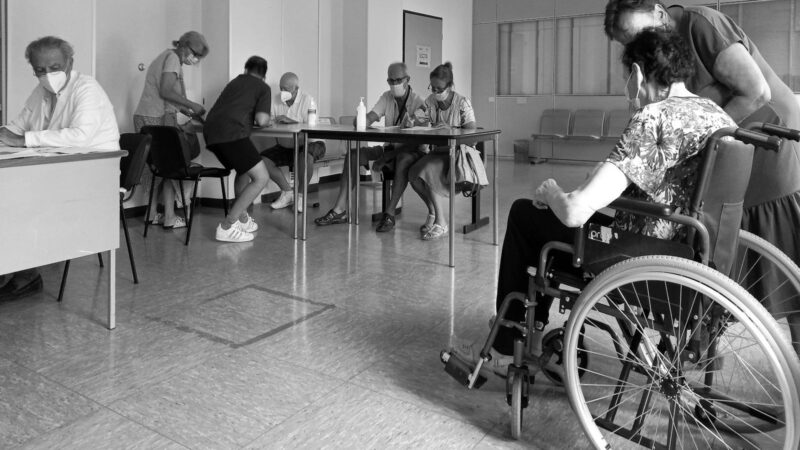 Grayscale Photo of People Sitting at the Table