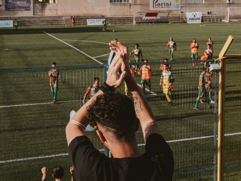 a group of people standing on top of a soccer field