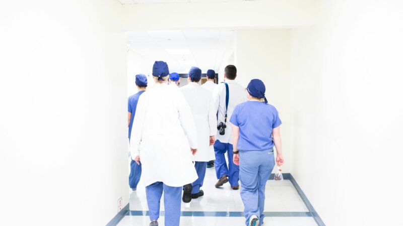 group of doctors walking on hospital hallway