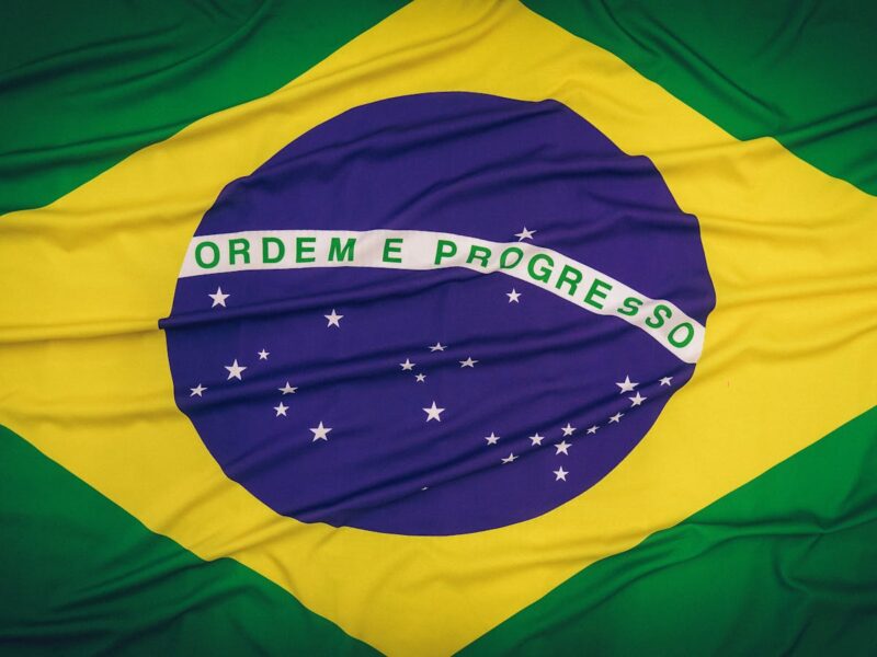 Close-up of the Brazilian flag featuring 'Ordem e Progresso' text and symbolic elements.